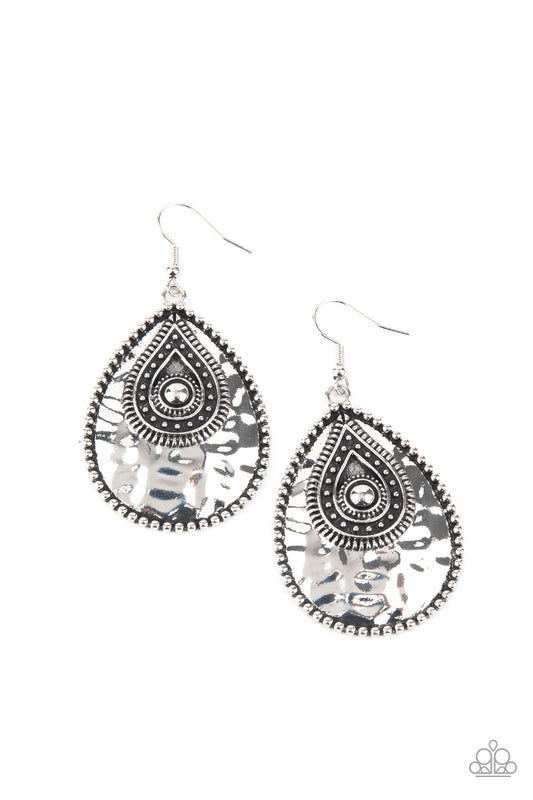 Bordered in antiqued studs, a hammered silver teardrop is embellished with matching rustic details for a handcrafted finish. Earring attaches to a standard fishhook fitting.  Sold as one pair of earrings.