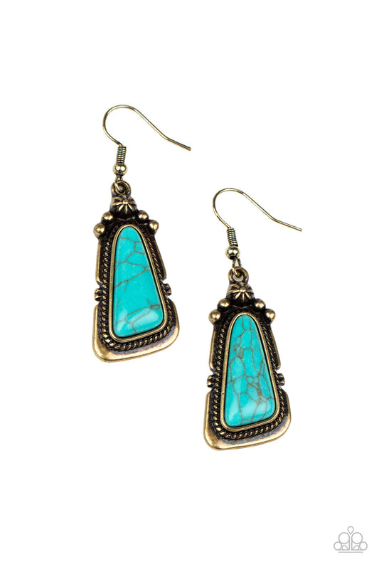 An imperfect turquoise stone is pressed into the center of a studded brass frame featuring brassy rope-like texture. Earring attaches to a standard fishhook fitting.  Sold as one pair of earrings.