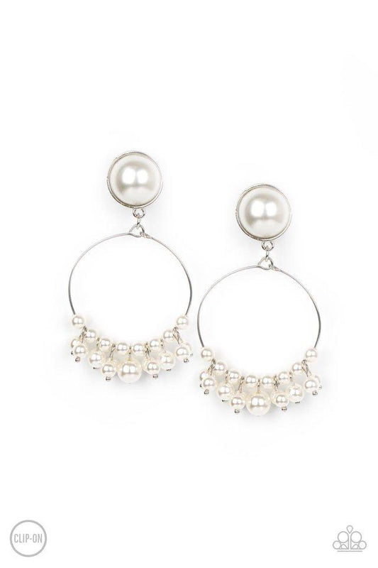 Featuring a pearl dotted fringe, a dainty silver wire hoop swings from the bottom of a matching pearl dotted fitting for a refined flair. Earring attaches to a standard clip-on fitting.  Sold as one pair of clip-on earrings.