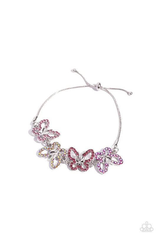 Attached to a silver snake chain, a whimsical collection of multicolored green, opalescent, and iridescent-dotted silver butterflies flutter along the wrist. Features a sliding bead closure. Due to its prismatic palette, color may vary.

Sold as one individual bracelet.