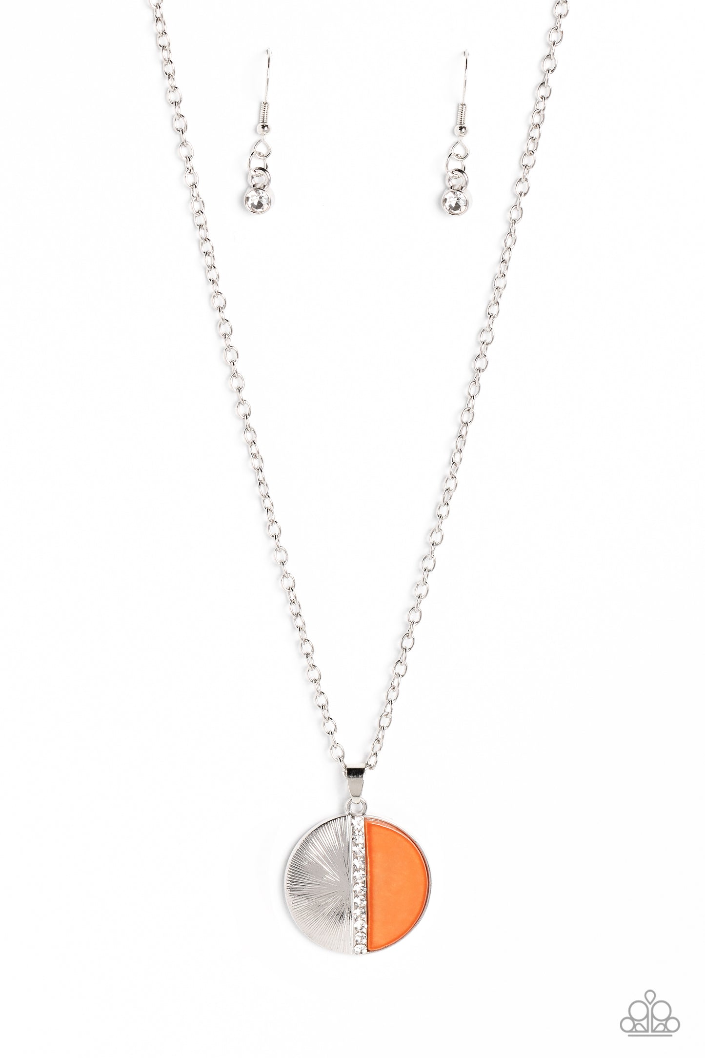 Embossed in radiant linear textures, a half-circle silver frame is nestled next to a half-circle coral shell for a colorful finish. White rhinestones dot down the center of the pendant for a spritz of glitz down the neckline. Features an adjustable clasp closure.  Sold as one individual necklace. Includes one pair of matching earrings.