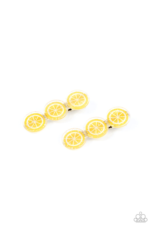 Sprinkled in sparkle, a zesty trio of lemon frames coalesce into a citrusy pair of hair clips. Features standard hair clips on the back.  Sold as one pair of hair clips.