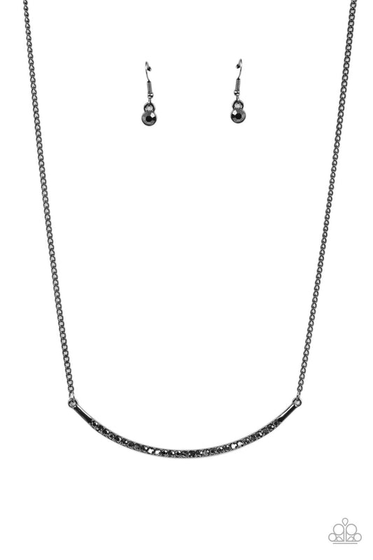 Encrusted in smoky hematite rhinestones, a curved gunmetal bar bows below the collar for a smoldering style. Features an adjustable clasp closure.  Sold as one individual necklace. Includes one pair of matching earrings.