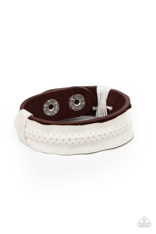 Featuring tactile stitching down the center, a white piece of vinyl-like leather is knotted in place across the front of a red leather band, creating a one-of-a-kind centerpiece around the wrist. Features an adjustable snap closure.  Sold as one individual bracelet.