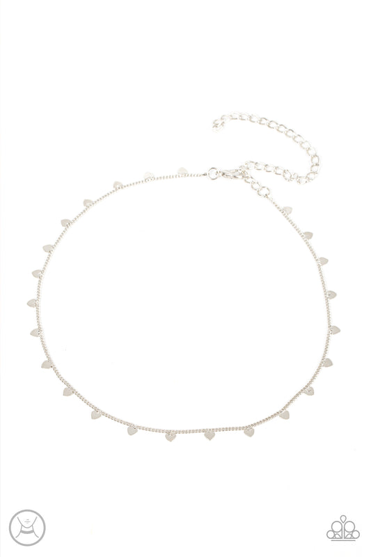 Dainty silver hearts dance from a dainty silver chain around the neck, creating a flirtatious fringe. Features an adjustable clasp closure.  Sold as one individual choker necklace. Includes one pair of matching earrings.