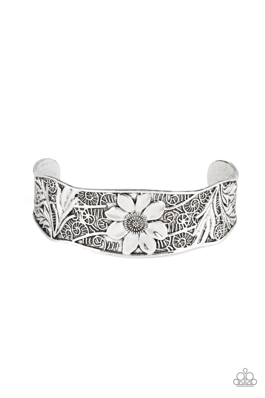 The front of an asymmetrical silver cuff is stamped and embossed in lacy vines and a leafy floral pattern for a whimsical fashion.  Sold as one individual bracelet.