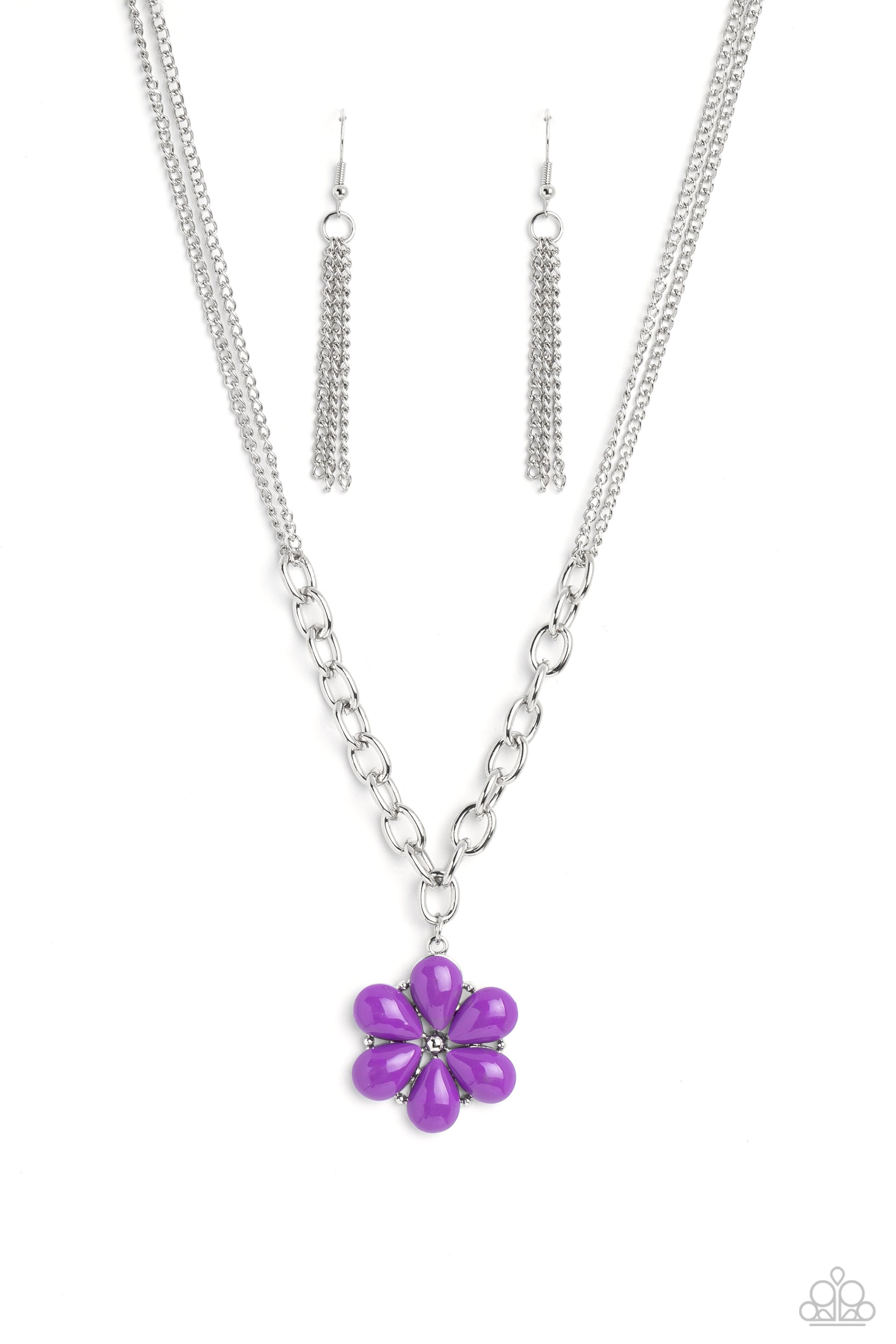 Purple acrylic petals bloom from and around silver-studded accents and a studded center. The colorful display hangs from a collection of thick silver oval links that interlock and hang below a double-layered silver chain for a bright, floral finish.  Sold as one individual necklace. Includes one pair of silver fringe earrings.