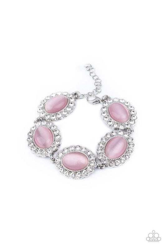 Dotted with glowing Pink Nougat cat's eye stone centers, glassy white rhinestone encrusted frames glamorously link around the wrist in a sparkly statement-making fashion. Features an adjustable clasp closure.  Sold as one individual bracelet.
