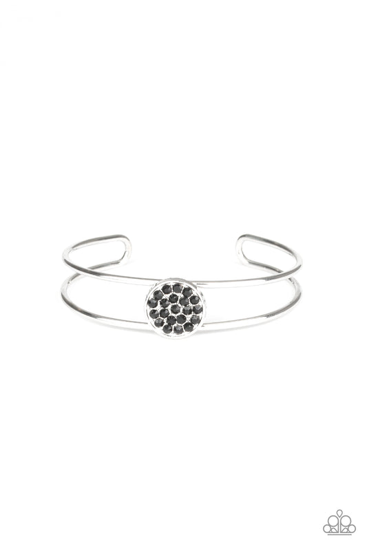 Glittery black rhinestones are encrusted along the front of a shimmery silver disc atop the center of a dainty silver cuff for a dazzling look.  Sold as one individual bracelet.