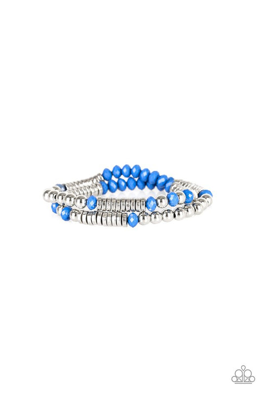 Classic silver beads, faceted Nebulas Blue beads, and dainty silver discs are threaded along stretchy bands, creating shimmery layers across the wrist.

Sold as one set of two bracelets.