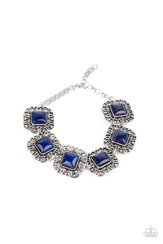 Dotted with blue cat's eye stones, square filigree filled silver frames delicately link around the wrist for a dreamy display. Features an adjustable clasp closure.  Sold as one individual bracelet.