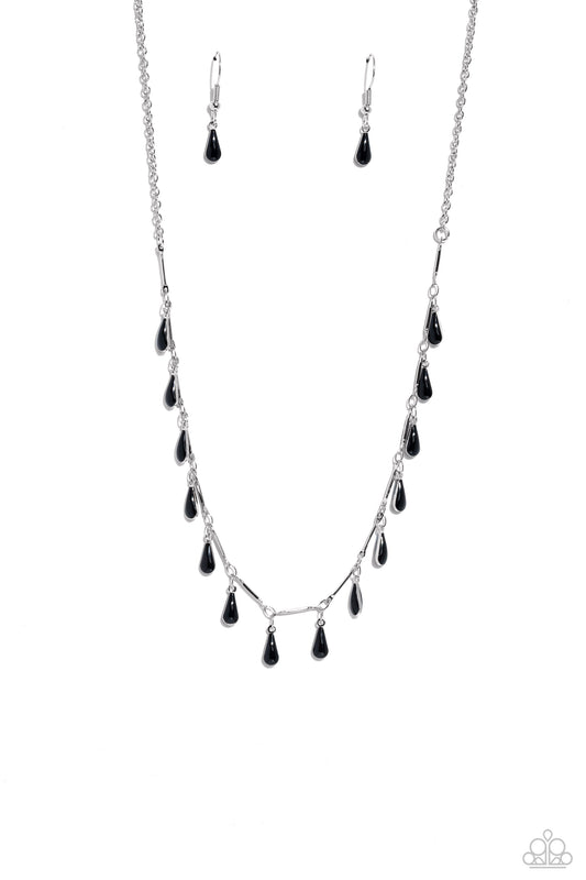 Infused along a dainty silver chain, thin silver bars and dainty, elongated black teardrops drip down the neckline for a fashionable, subtle pop of color. Features an adjustable clasp closure.  Sold as one individual necklace. Includes one pair of matching earrings.