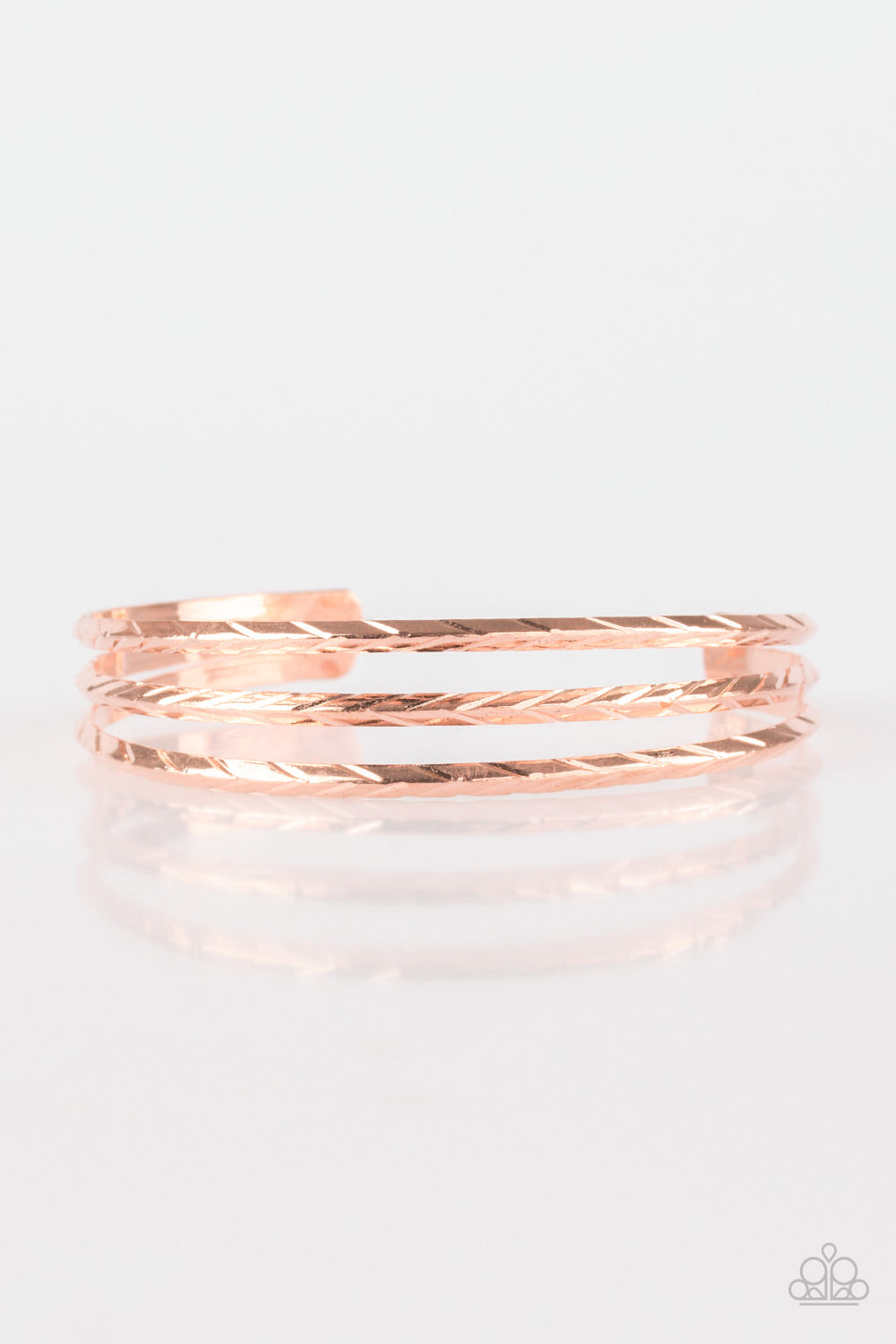 Etched in shimmery geometric patterns, glistening silver bars arc across the wrist, coalescing into a dainty cuff.  Sold as one individual bracelet.