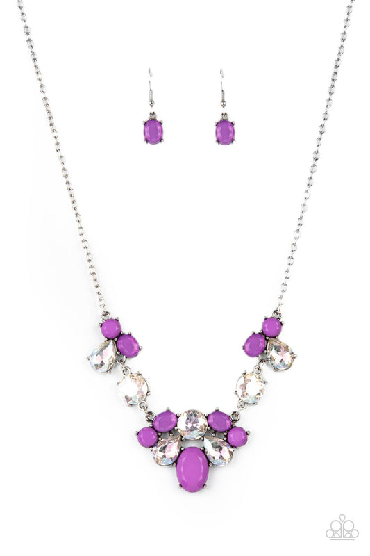 Varying in opacity and shape, mismatched purple beads attach to oversized white rhinestones, creating bubbly frames that delicately link into an ethereal display below the collar. Features an adjustable clasp closure  Sold as one individual necklace. Includes one pair of matching earrings.