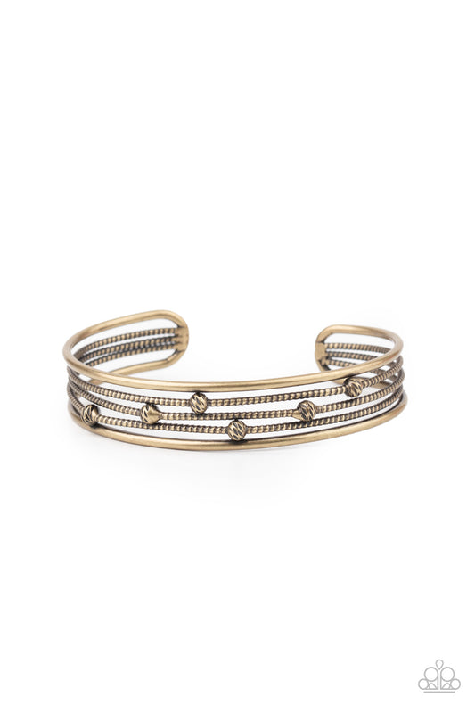 Dotted in ornate brass beads, textured brass wires layer between two smooth brass bars, stacking into an edgy cuff around the wrist.  Sold as one individual bracelet.