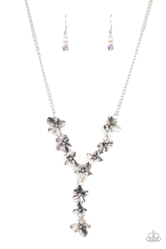 Dotted with dainty purple rhinestone centers, whimsical silver flowers delicately link into an extended pendant below the collar for an ethereal fashion. Features an adjustable clasp closure.  Sold as one individual necklace. Includes one pair of matching earrings.