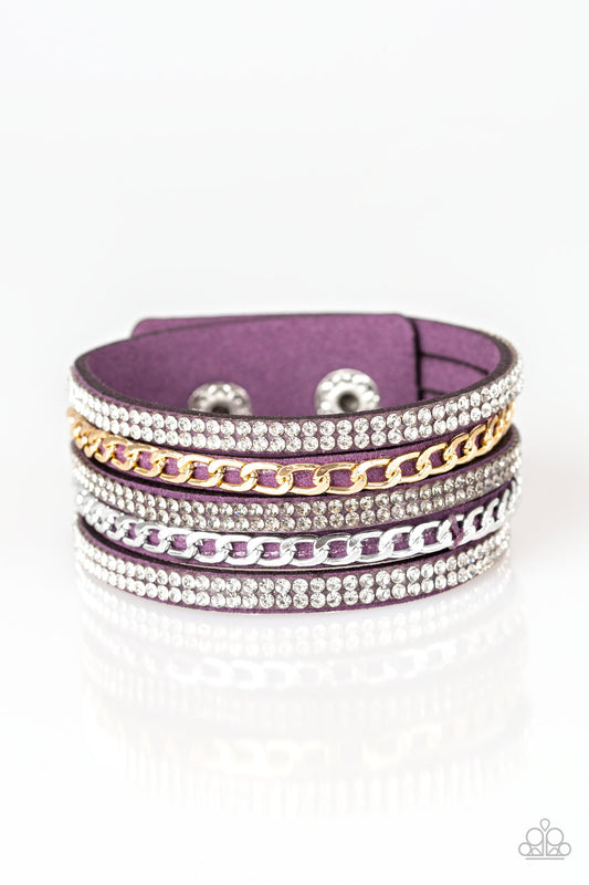 Glassy white and smoky rhinestones are encrusted along strands of purple suede. Glistening silver and gold chains are added to the bands, adding edgy industrial shimmer to the sassy palette. Features an adjustable snap closure.  Sold as one individual bracelet.