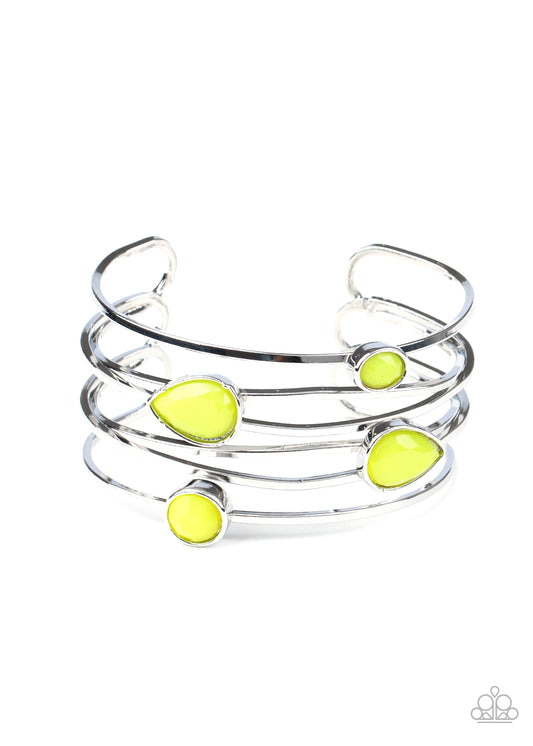Varying in shape, a neon collection of faceted Green Sheen beads haphazardly dot the tops of imperfect crisscrossing silver bars, coalescing into a colorfully retro cuff around the wrist.  Sold as one individual bracelet.