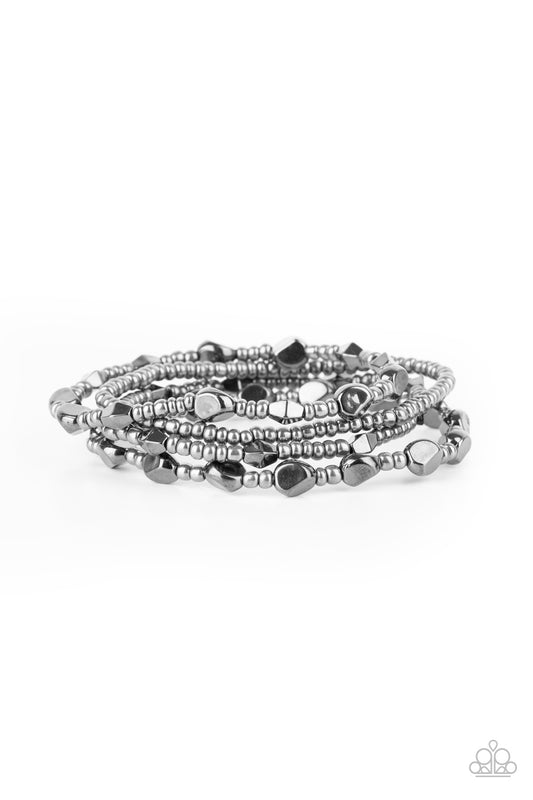 A shimmery collection of dainty gunmetal seed beads and faceted gunmetal accents are threaded along stretchy bands around the wrist, creating glistening layers.

Sold as one set of four bracelets.