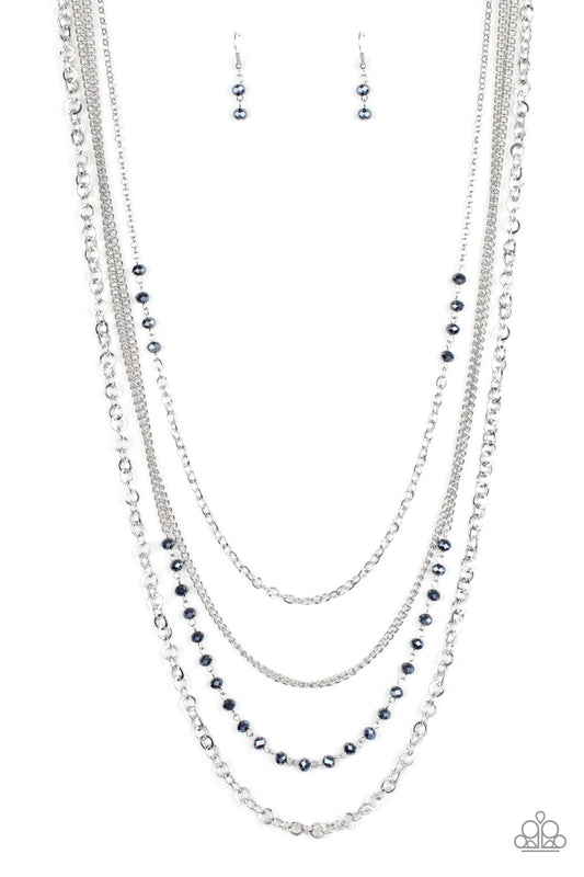 Featuring sections of faceted metallic blue beads, a collision of mismatched silver chains drapes down the chest, creating flickering layers. Features an adjustable clasp closure.  Sold as one individual necklace. Includes one pair of matching earrings.
