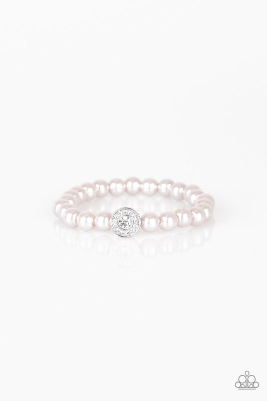 Silver pearls and a white rhinestone encrusted silver charm are threaded along a stretchy band, creating a glamorous centerpiece atop the wrist.

Sold as one individual bracelet.