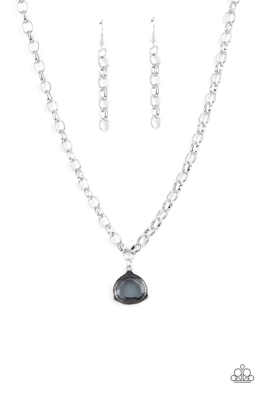 An oversized smoky gem is pressed into a pronged silver fitting at the bottom of a chunky silver chain, creating a dramatic pendant below the collar. Features an adjustable clasp closure.  Sold as one individual bracelet.