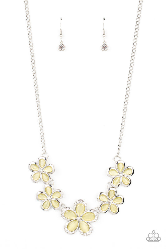 Bordered in silver accents, dainty yellow cat's eye stone petals bloom from dainty white rhinestone centers, linking into ethereal blossoms below the collar. The centermost daisy is dotted in glassy white rhinestones, adding dazzling dimension to the floral fairytale. Features an adjustable clasp closure.  Sold as one individual necklace. Includes one pair of matching earrings.