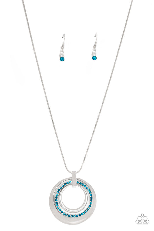 Glistening silver hoops and a blue rhinestone encrusted ring swing from the bottom of a lengthened silver chain, creating a glamorous pendant. Features an adjustable clasp closure.

Sold as one individual necklace. Includes one pair of matching earrings.