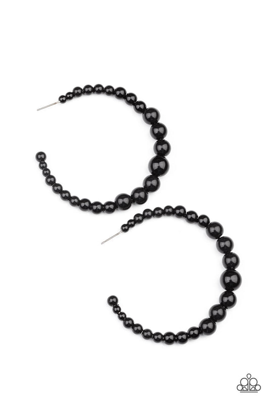 Gradually increasing in size at the center, a classic row of polished black beads are threaded along an oversized hoop for a posh finish. Earring attaches to a standard post fitting. Hoop measures approximately 2 1/4" in diameter.  Sold as one pair of hoop earrings.
