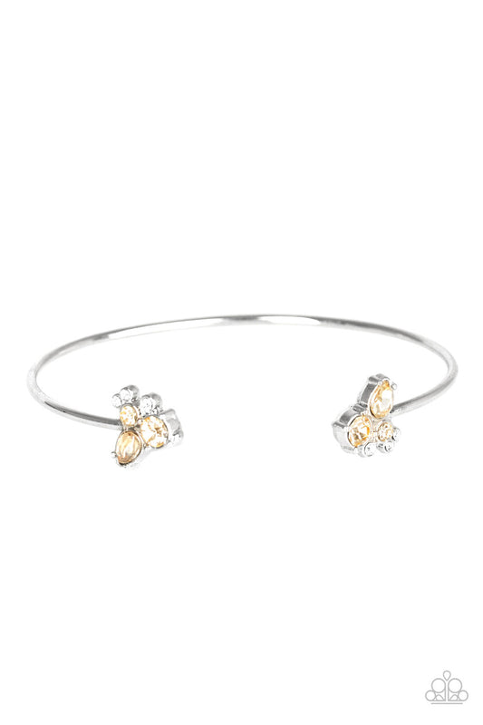 Varying in shape, golden topaz and glitter white rhinestones join at both ends of a dainty silver cuff, creating refined fittings.  Sold as one individual bracelet.