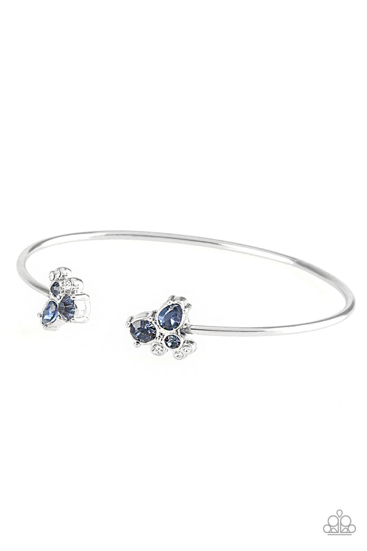 Varying in shape, glittery blue and white rhinestones join at both ends of a dainty silver cuff, creating refined fittings.  Sold as one individual bracelet.
