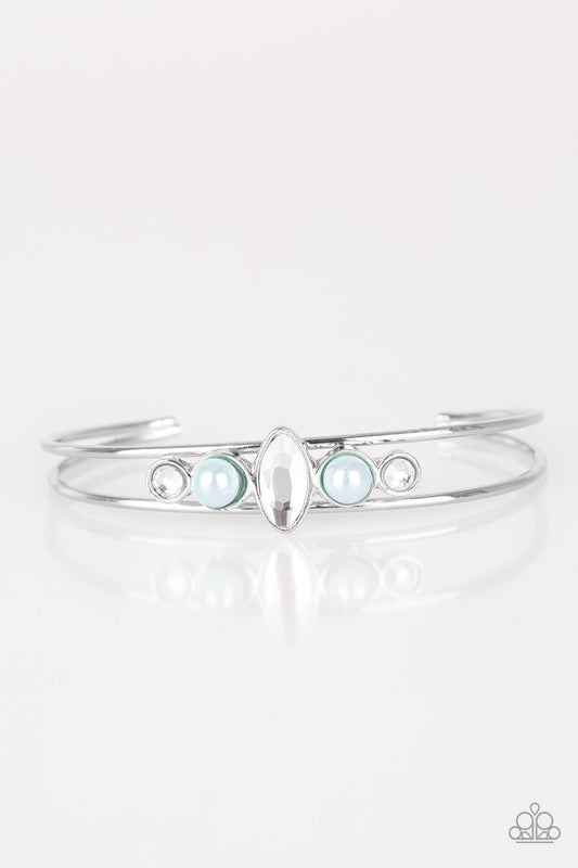 Varying in shape and shimmer, glittery white rhinestones and pearly blue beads are encrusted along the top of a dainty silver cuff for a refined look.  Sold as one individual bracelet.