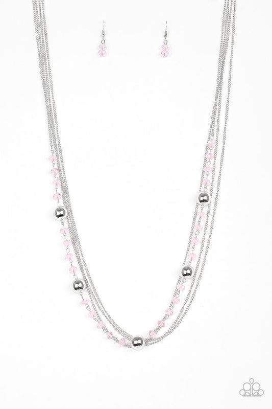 Infused with rows of shimmery silver chains, a strand of glittery pink crystal-like beads and classic silver accents drape across the chest for a regal finish. Features an adjustable clasp closure.  Sold as one individual necklace. Includes one pair of matching earrings.