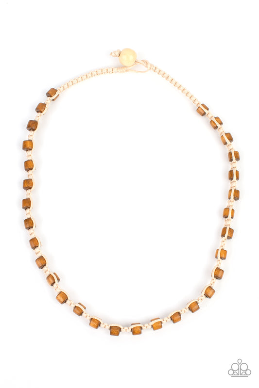 Round wooden beads are knotted into a rustic natural cord creating an earthy homespun necklace below the collar. Features a button loop closure.  Sold as one individual necklace.
