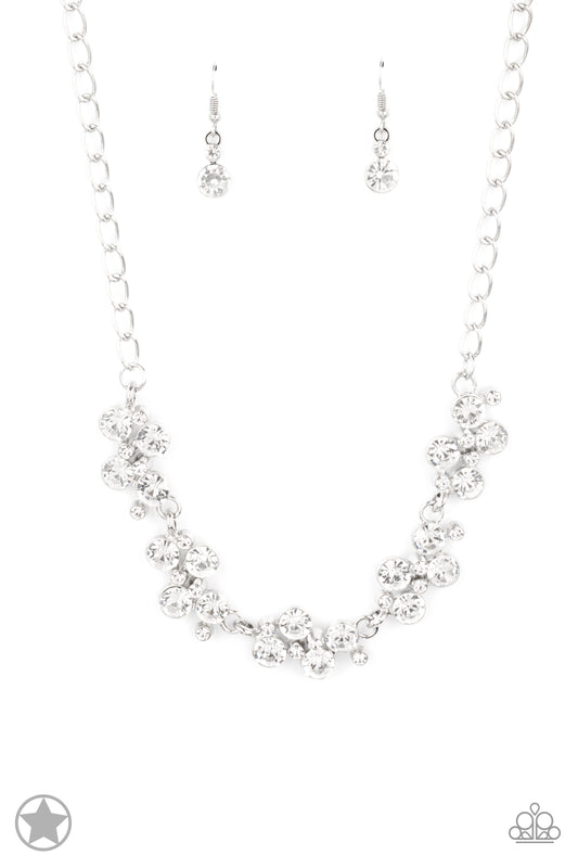 Connecting to a classic silver chain, clusters of dazzling white rhinestones drape along the neckline, creating a sparkling statement. Daintier white rhinestones are sprinkled between the larger rhinestones, creating additional luminous detail to the timeless design. Features an adjustable clasp closure.  Sold as one individual necklace. Includes one pair of matching earrings.