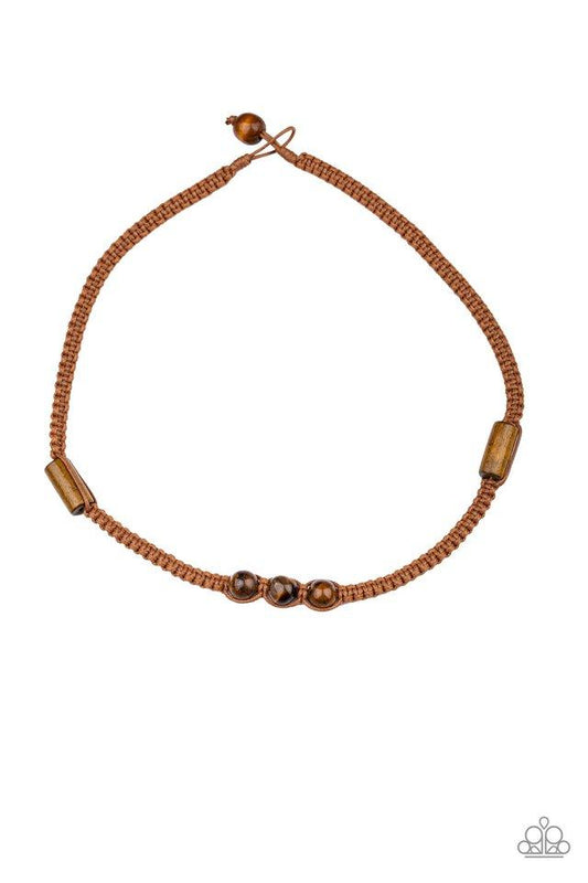 An assortment of wooden accents and glassy brown beads are knotted in place along a braided cord, creating a seasonal look below the collar. Features a button loop closure.  Sold as one individual necklace.
