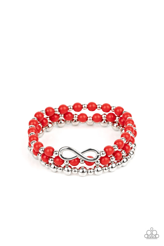 Fiery red and shiny silver beads are threaded along stretchy bands, creating colorful layers around the wrist. A dainty silver infinity charm adorns one strand for a whimsical finish.

Sold as one set of three bracelets.