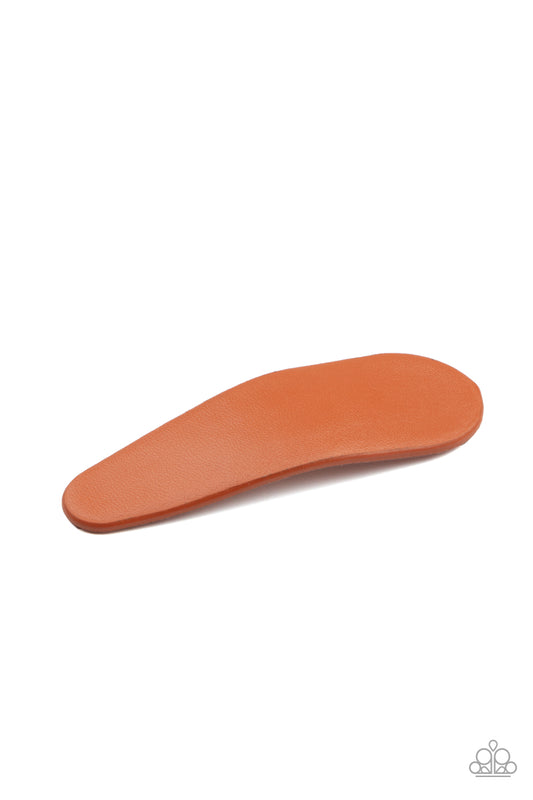 A piece of brown vinyl-like fabric covers a classic silver frame, creating a colorful hair clip. Features a standard snap hair clip on the back.  Sold as one individual hair clip.