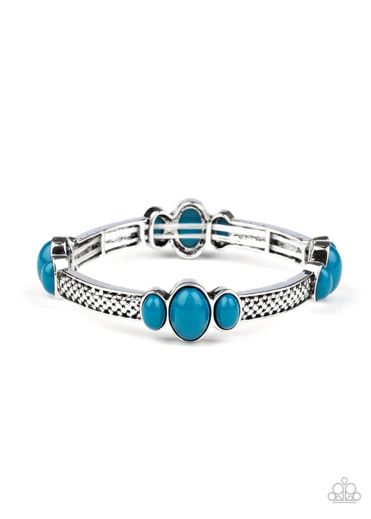 Trios of bubbly blue beads are attached to the top of textured silver bars, coalescing into decorative frames. The colorful frames are threaded along stretchy bands around the wrist for a trendy pop of color.  Sold as one individual bracelet.