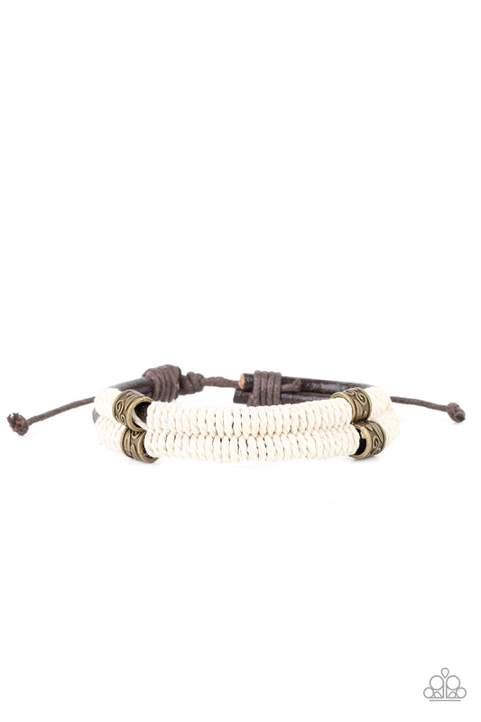 Infused with decorative brass beads, white twine-like cording knots around two shiny brown leather cords around the wrist for a seasonal flair. Features an adjustable sliding knot closure.  Sold as one individual bracelet.