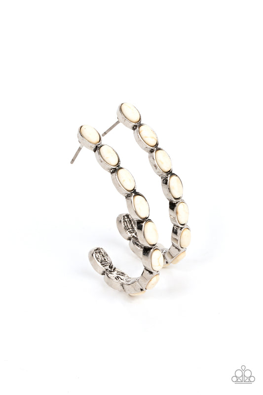 Small white stones pressed into simple silver oval frames stack end to end as they fall from the ear and delicately curve into a J-shaped hoop for a refreshing finish. Earring attaches to a standard post fitting. Hoop measures approximately 1" in diameter.  Sold as one pair of hoop earrings.