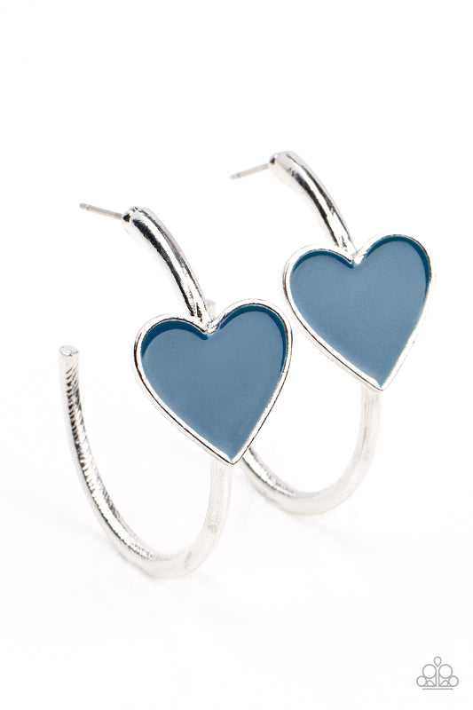 A charming Mykonos Blue heart adorns the front of a classic silver hoop resulting in a whimsical fashion. Earring attaches to a standard post fitting. Hoop measures approximately 1 1/4" in diameter.  Sold as one pair of hoop earrings.