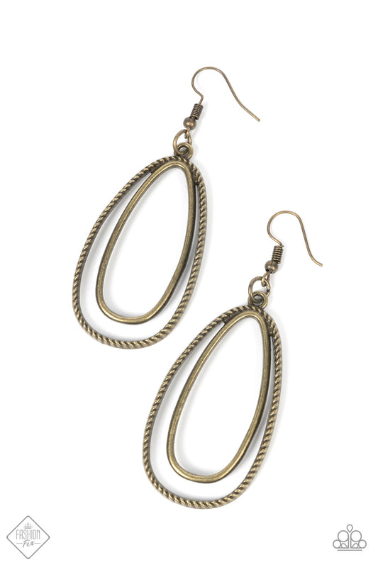 Layered one inside the other, a smooth oval hoop brushed in antiqued brass texture is paired with a rustic frame wrapped in rope-like texture creating an airy, yet rustic design. Earring attaches to a standard fishhook fitting.  Sold as one pair of earrings.