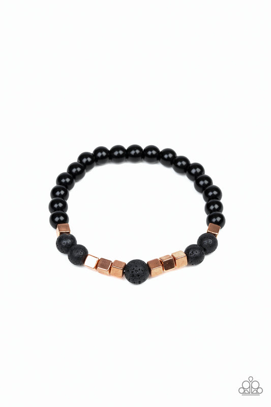 A collection of glassy black beads, earthy lava rock beads, and shimmery shiny copper cubes are threaded along a stretchy band around the wrist for a seasonal flair.  Sold as one individual bracelet.
