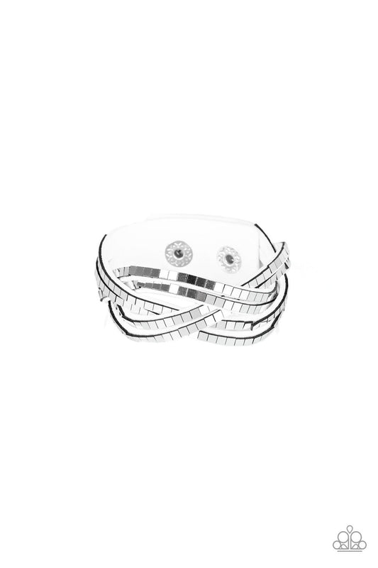 Flat silver cubes are encrusted along rows of braided white suede for an edgy look. Features an adjustable snap closure.  Sold as one individual bracelet.