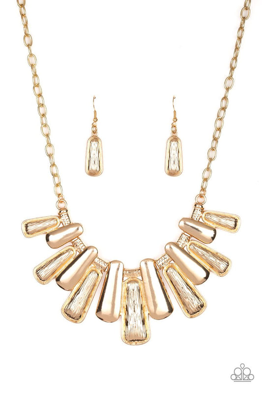 Featuring smooth and etched finishes, a collection of glistening gold plates link below the collar, creating a blinding fringe. Features an adjustable clasp closure.  Sold as one individual necklace. Includes one pair of matching earrings.