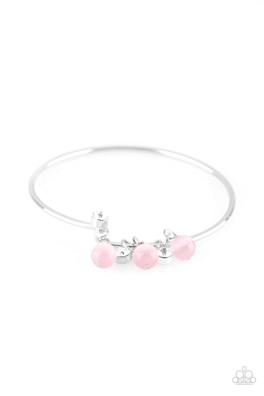 Glassy pink beads and glittery white rhinestones slide along a dainty silver wire infused with a rhinestone encrusted fitting, creating a versatile adjustable like bangle. Features a hinged closure.  Sold as one individual bracelet.