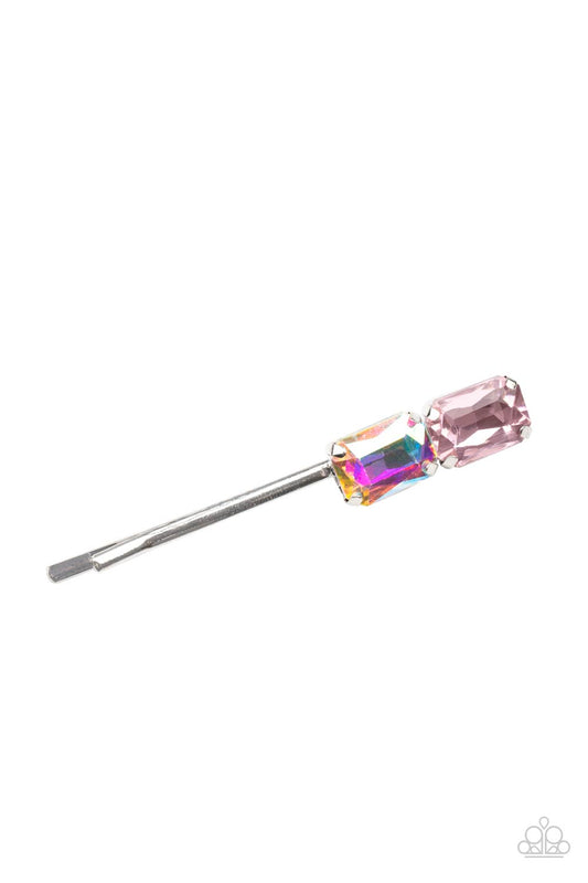 Featuring elegant emerald style cuts, an oversized pair of pink and iridescent rhinestones adorn the end of a classic silver bobby pin.  Sold as one individual decorative bobby pin.