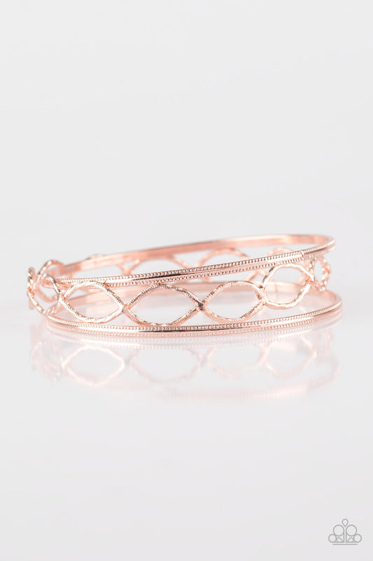 Featuring serrated textures, mismatched rose gold bangles stack across the wrist for a casual look.  Sold as one set of three bracelets.