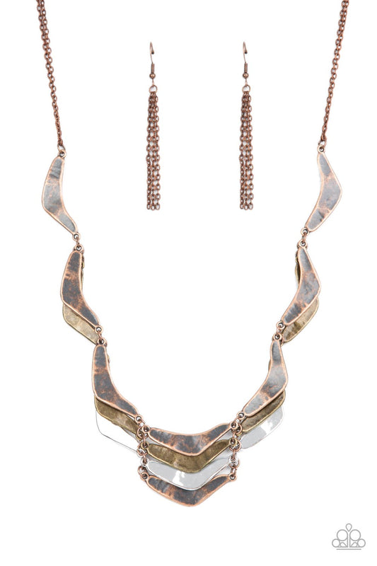 Featuring a rustic hammered finish, boomerang shaped silver, brass, and copper plates delicately link into artisan-inspired layers below the collar. Features an adjustable clasp closure.  Sold as one individual necklace. Includes one pair of copper fringe earrings.